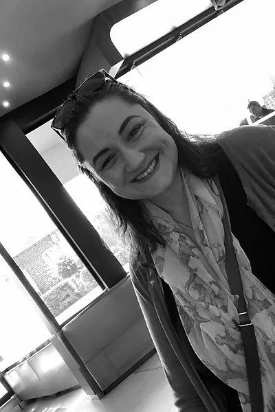 Annelize travelling, smiling in a doorway